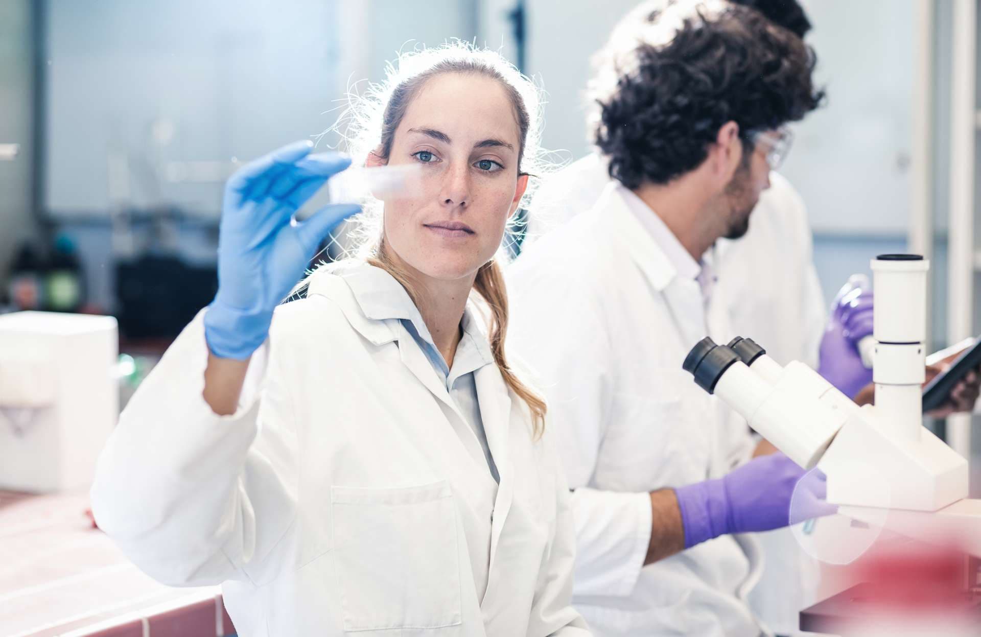 Scientist Looking at a Microscope Slide