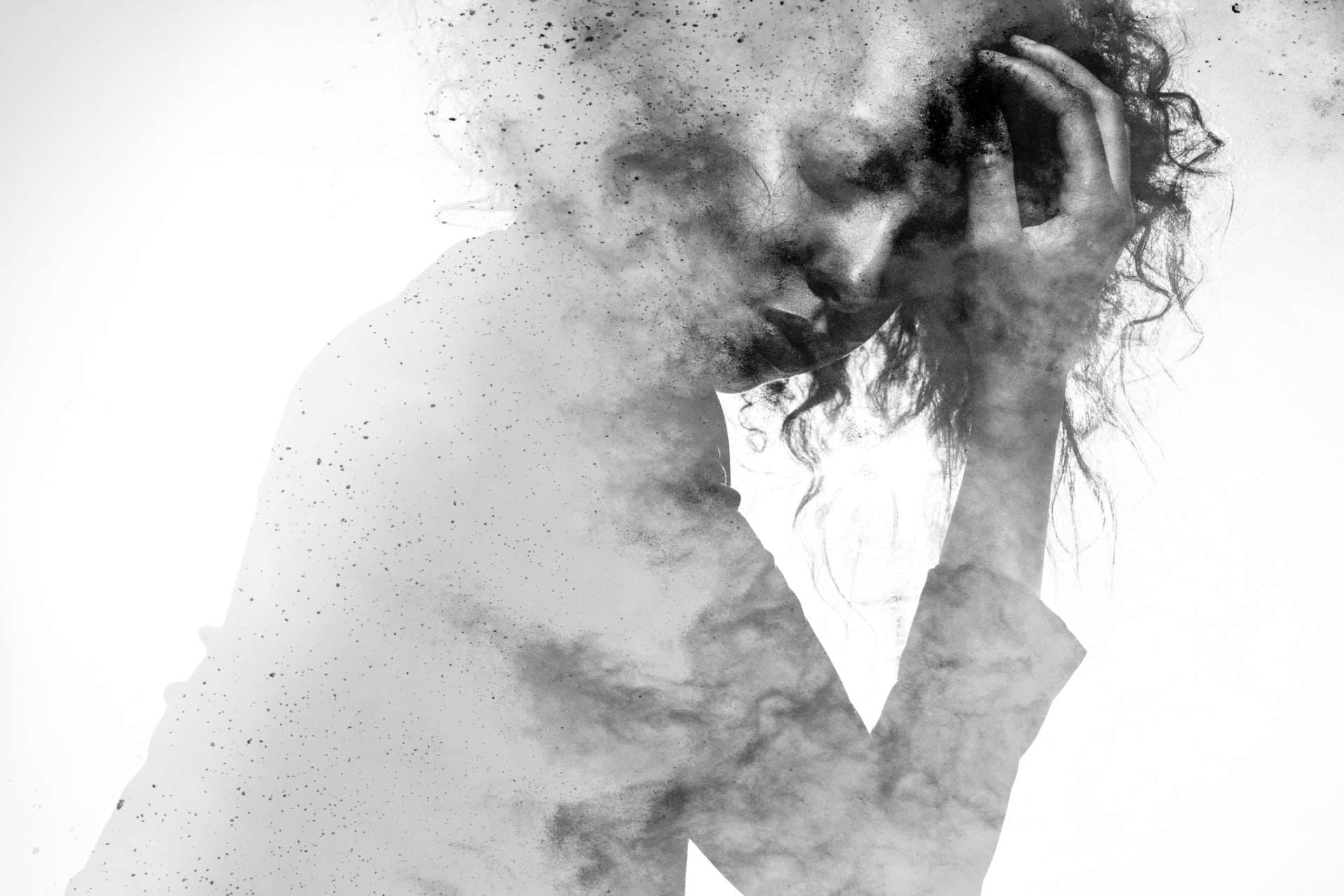 Subtile Frauenform in einer unglücklichen Pose, doppelt belichtet mit einem monochromen Farbspritzer-Fotoeffekt