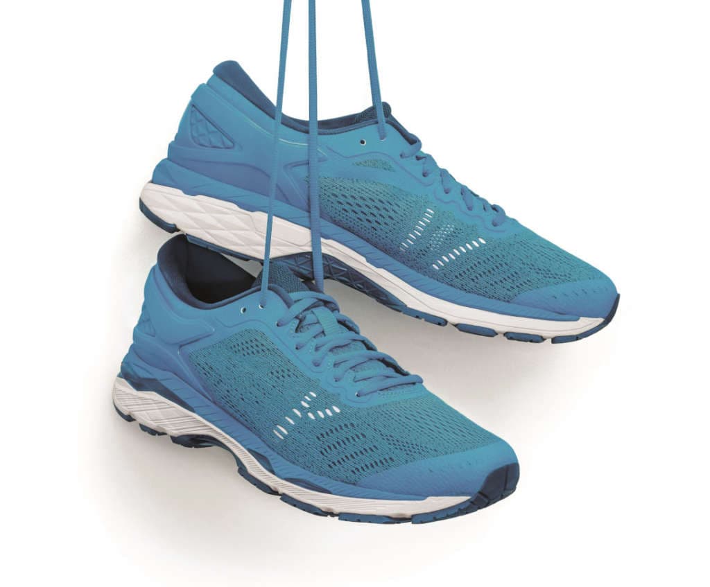 A pair of blue running shoes hanging from a hook. Isolated on a white background.