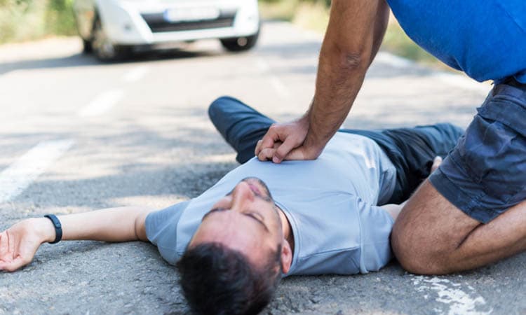 man receiving first aid after a car accident
