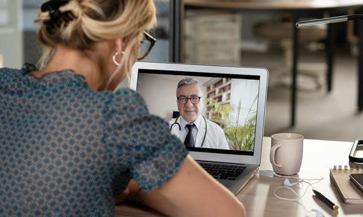 Young woman talking with doctor on digital tablet