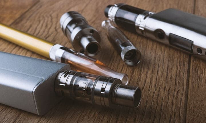 vaping devices or electronic cigarette on a wooden background