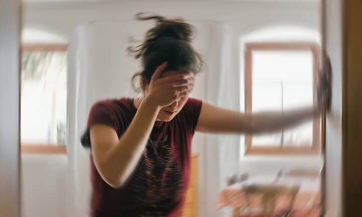 Woman suffering from vertigo or dizziness or other health problem of brain or inner ear.
