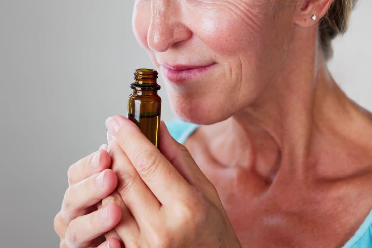 Ältere Dame riecht an Aromaöl