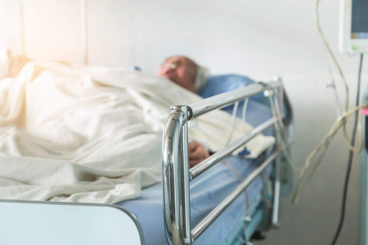 Ältere Patientin in einem Krankenhausbett auf der Station.