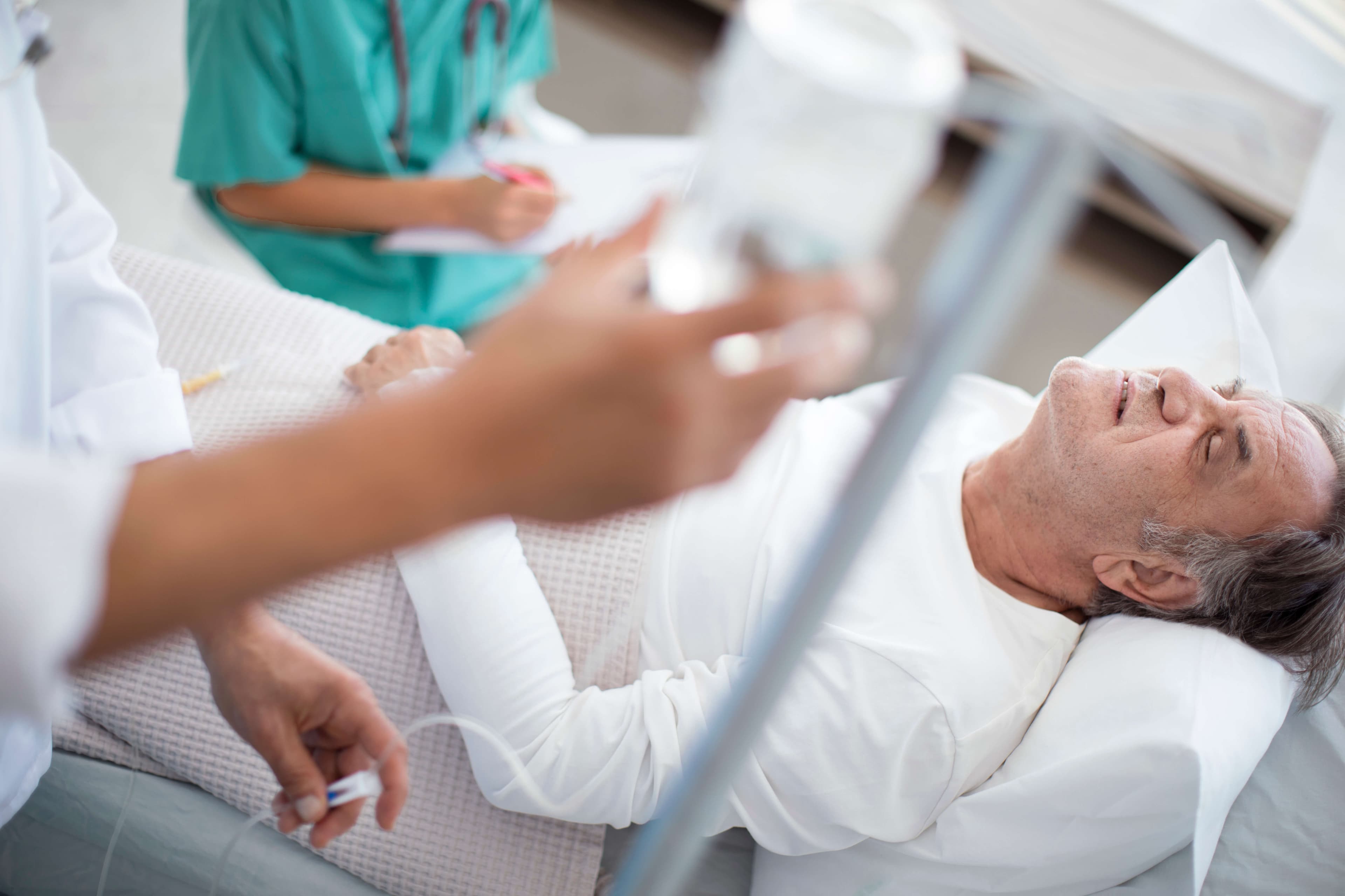 Senior man is seriously ill in hospital bed