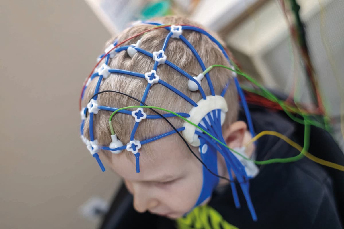 A boy’s brain is examined on an EEG machine. Electroencephalogra