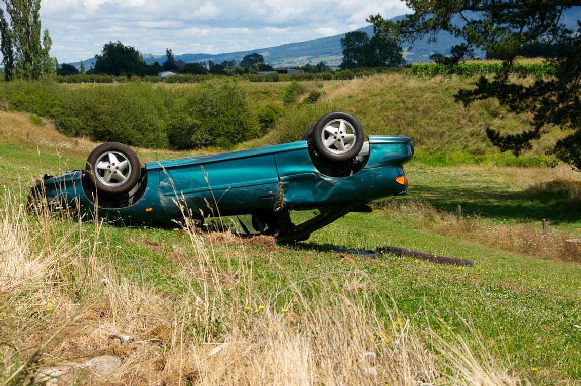 Grünes Auto liegt auf dem Dach